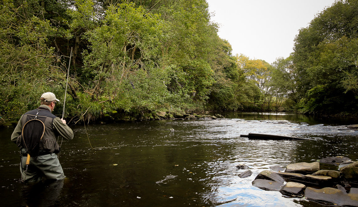 Jonathan Hoyle fishing the weir above Copley Bridge, River Calder near Halifax